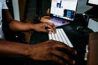 person using white and black laptop computer by Kit (formerly ConvertKit) courtesy of Unsplash.